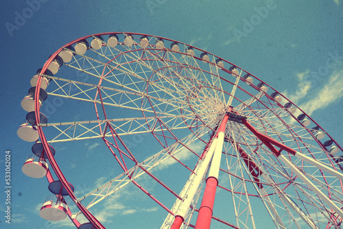 Beautiful large Ferris wheel against blue sky  low angle view
