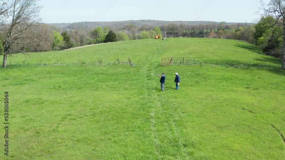 Surveyors During Land Survey Of A Vast Farmland Near Siloam Springs, Arkansas, USA - aerial pullback Surveyors During Land Survey Of A Vast Farmland Near Siloam Springs, Arkansas, USA - aerial pullback