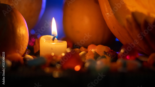 Candle illuminating some halloween pumpkins