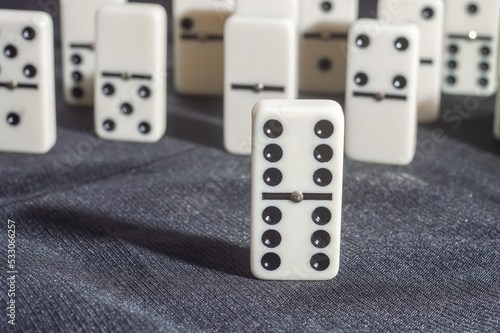 Several domino pieces positioned on a black background with light light