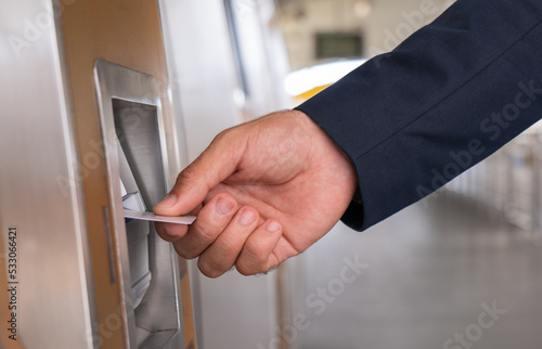 Hand of business man inserting card to the machine