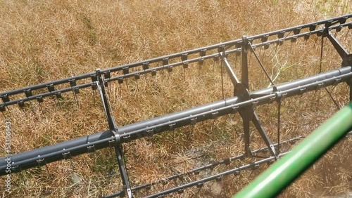 Blue-collar work concept. Unrecognizable caucasian farmer harvesting with the use of combine harvester. Operator's perspective. High quality 4k footage photo