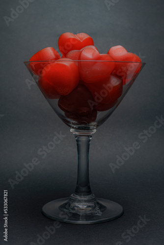 Red jelly hearts in champagne glass. photo