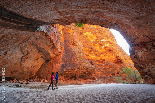 A couple walking in the cathedral gorge, Purnululu National Park (also known as Bungle Bungle), Western Australia.