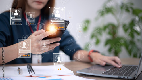 Tableau sur toile Online recruitment application specialist search service concept with virtual cards with rating and profile information on a smartphone in hand