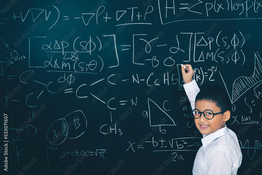 Male student writing mathematical formula in class Male student writing mathematical formula in class
