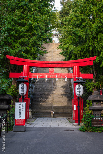 red torii gate of a japanese shrine in front of stairs