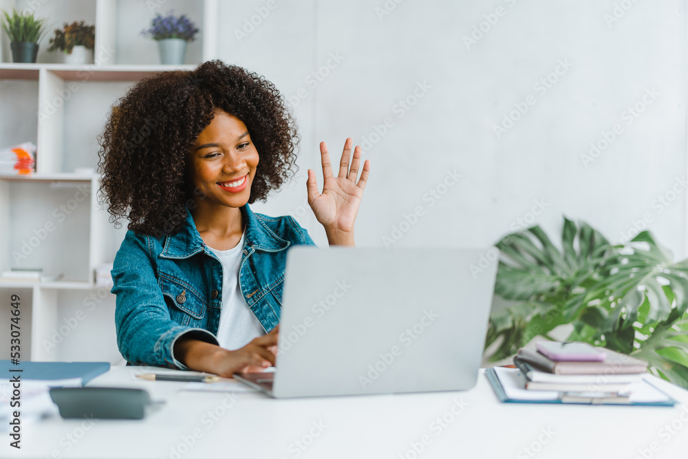 Happy young female worker having virtual online video call on laptop computer. Happy young female worker having virtual online video call on laptop computer.