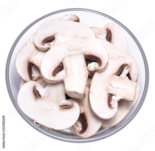 Sliced white champignon mushrooms in glass bowl isolated on white background