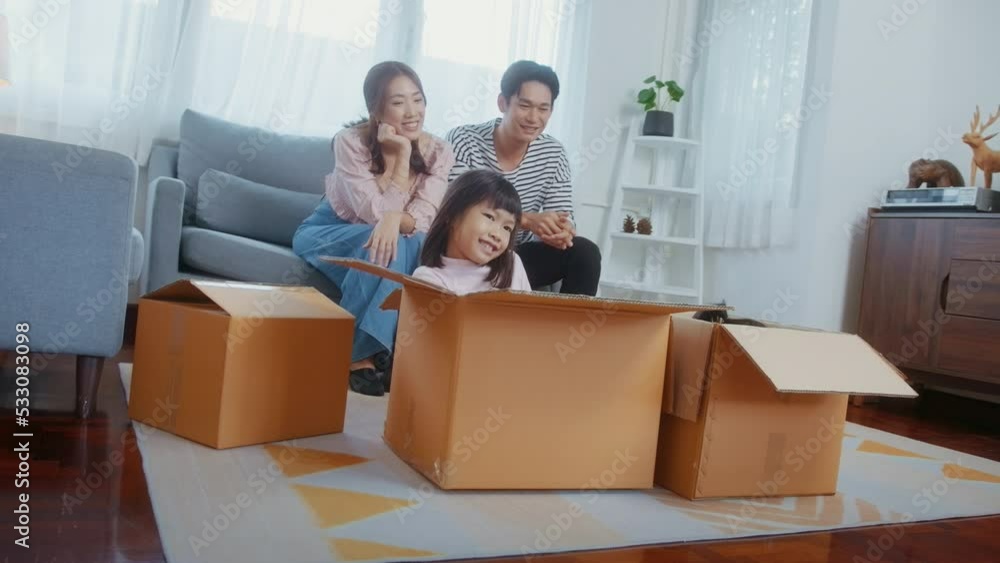 Asian family husband and wife and children with cardboard boxes having fun on moving day, Mortgage, loan, property and insurance concept. Asian family husband and wife and children with cardboard boxes having fun on moving day, Mortgage, loan, property and insurance concept.