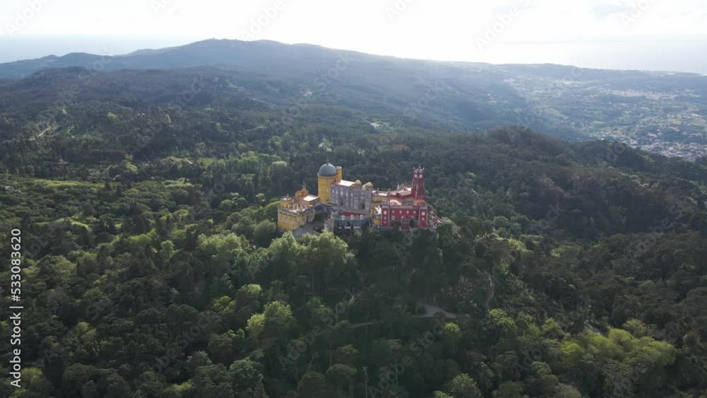 Aerial view of Pena Palace in Sintra, a Romanticist castle on hilltop surrounded by forest, Sintra, Lisbon, Portugal. Aerial view of Pena Palace in Sintra, a Romanticist castle on hilltop surrounded by forest, Sintra, Lisbon, Portugal.