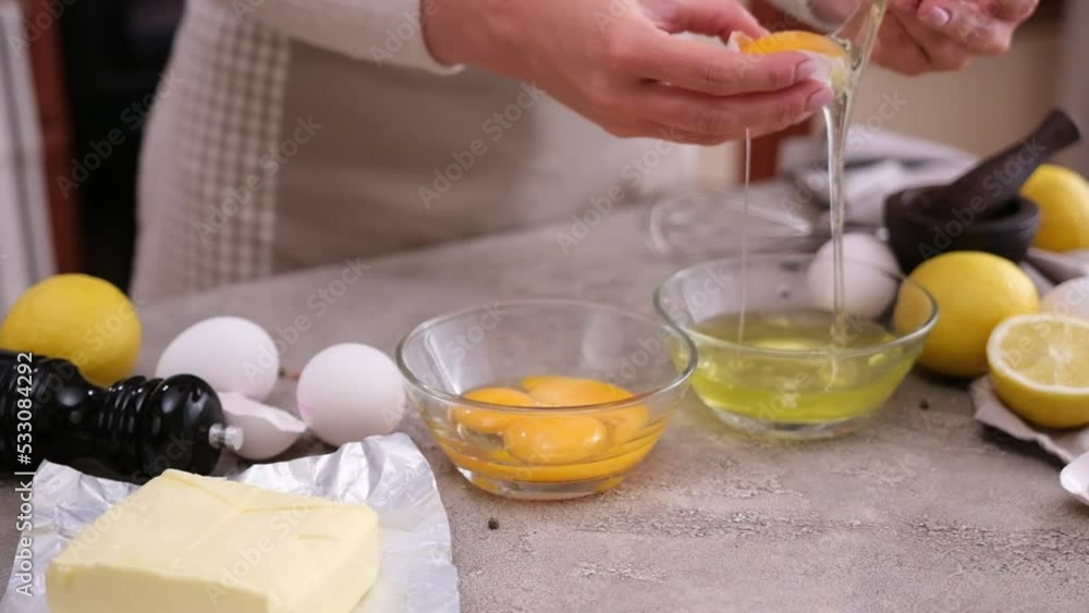 Woman beats egg into glass bowl separates white from yolk Woman beats egg into glass bowl separates white from yolk