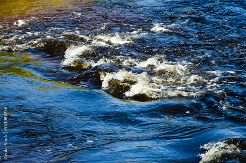 Overflow in the course of the river. The water reflects the vegetation beautifully.