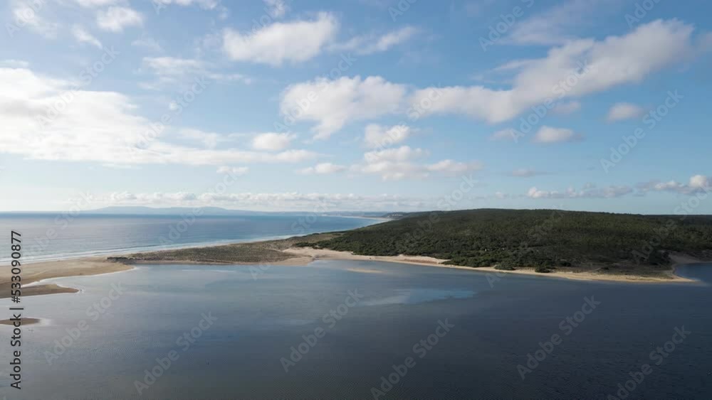 Aerial view of Lagoa de Albufeira, a natural lake meeting the Atlantic Ocean in south Portuguese coastline, Sesimbra Municipality, Setubal, Portugal. Aerial view of Lagoa de Albufeira, a natural lake meeting the Atlantic Ocean in south Portuguese coastline, Sesimbra Municipality, Setubal, Portugal.