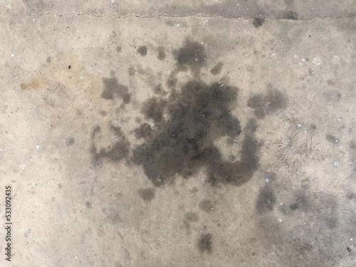 Black oil stain Spilled on messy concrete floor
