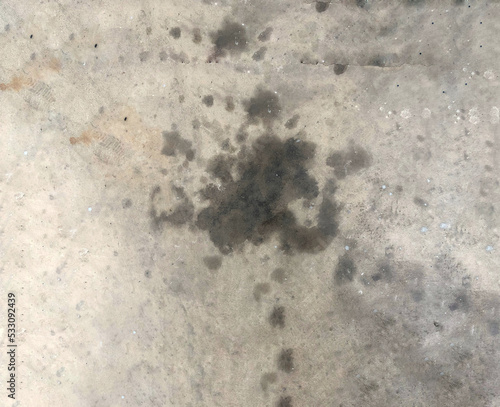 Black oil stain Spilled on messy concrete floor