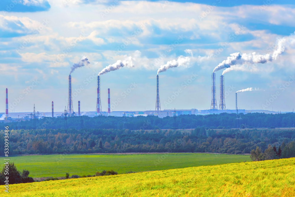 Industrial landscape. The pipes of a chemical fertilizer plant emit toxic smoke, carbon dioxide, polluting the air. The concept of transition to green technologies, energy crisis.