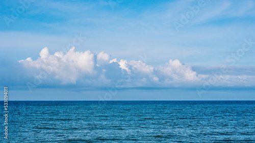 BANNER Atmosphere long panorama real photo beautiful summer white cloud clear blue sky horizon line calm sea. Concept paradise life. Design relax wallpaper background. More tone format in stock