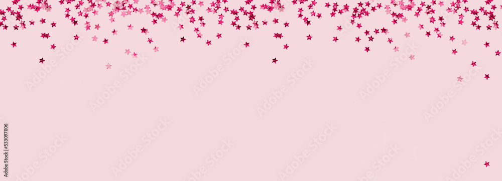 scattered pink holographic glitter confetti star shaped on candy pink background Flat lay top view copy space. Festive holiday pastel backdrop. Birthday, giveaway, Christmas, New Year banner scattered pink holographic glitter confetti star shaped on candy pink background Flat lay top view copy space. Festive holiday pastel backdrop. Birthday, giveaway, Christmas, New Year banner