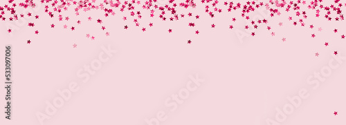 scattered pink holographic glitter confetti star shaped on candy pink background Flat lay top view copy space. Festive holiday pastel backdrop. Birthday, giveaway, Christmas, New Year banner