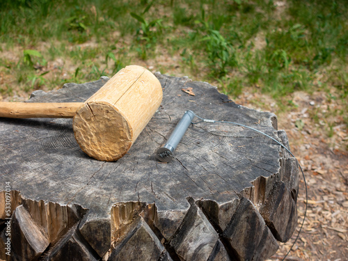 Wooden hammer on wooden stump on dwarf path Rogla, Slovenia.