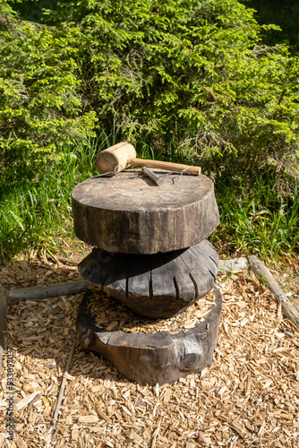 Wooden hammer on wooden stump on dwarf path Rogla, Slovenia.