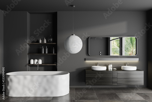 Grey bathroom interior with double sink and tub with shelf