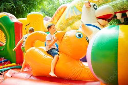 Fotografia Happy boy having a lots of fun on a colorful inflate castle