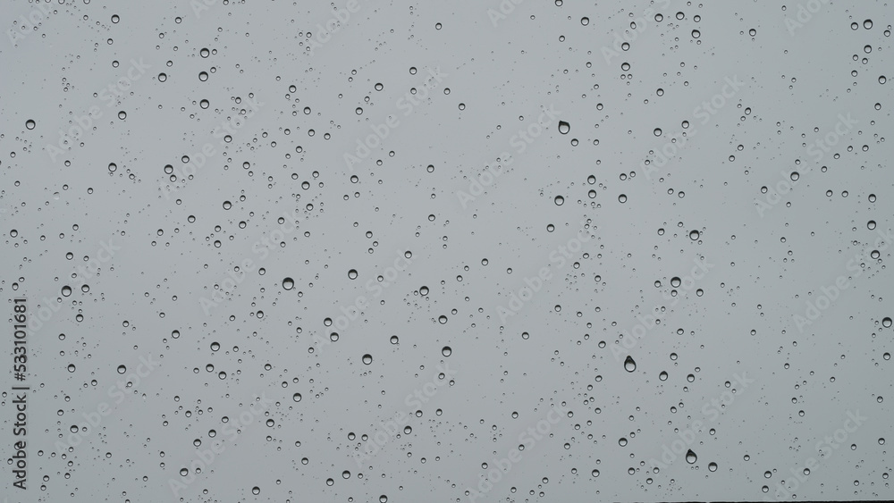 Real background of rain hitting glass with protective coating Real background of rain hitting glass with protective coating