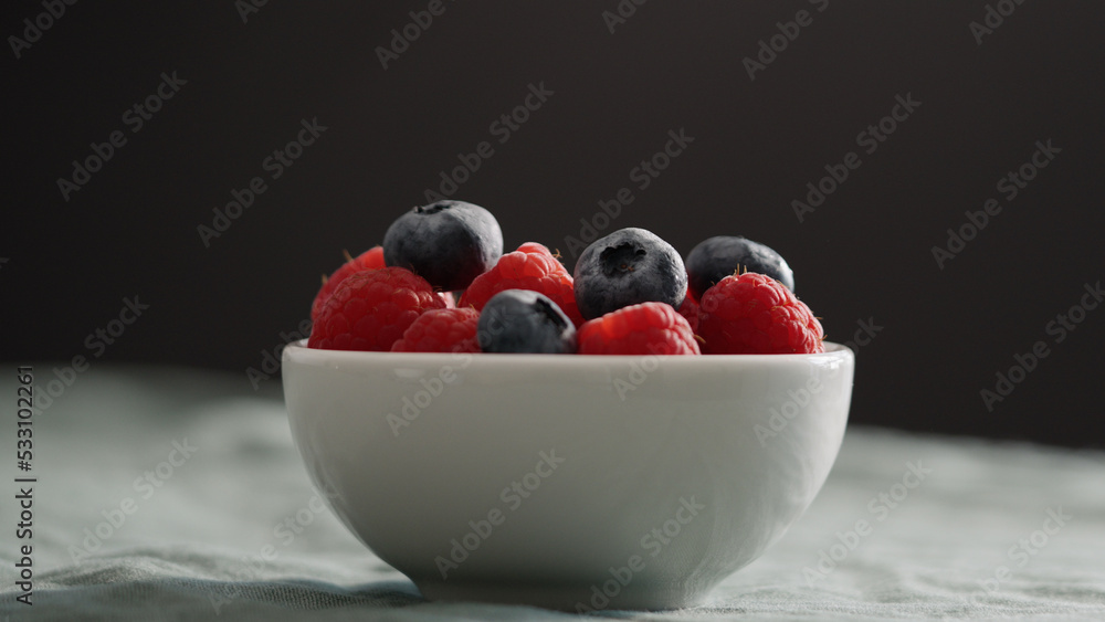 Fresh berries in bowl on linen napkin Fresh berries in bowl on linen napkin