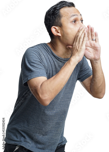 Close up portrait of a young asian man shouting loud with arm at his face isolated on studio background