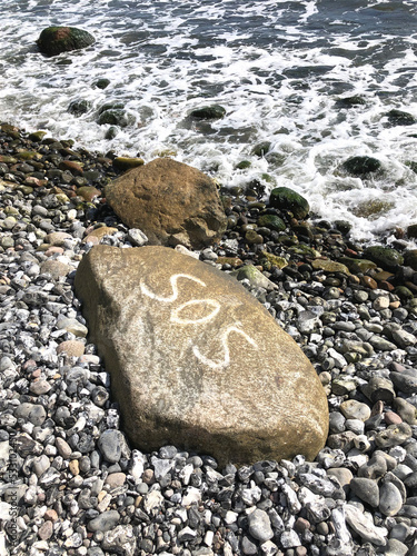 stones on the beach, sos written on a stone, sea photo