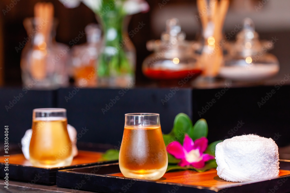 Herbal spa tea in a glass cups with small refreshment towels