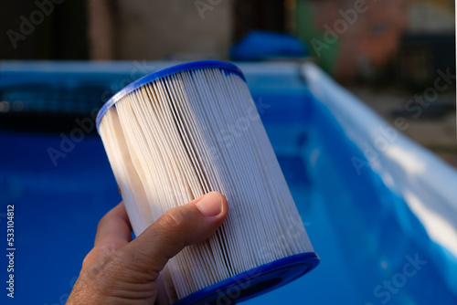 Replacement Pool Filter Cartridge in a woman's hand. Filter reuse.  photo