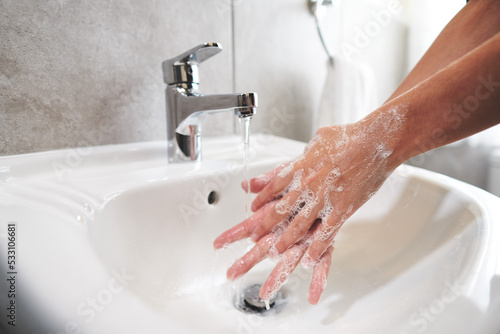 Girl washing hands at home