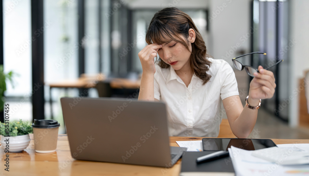 Tired asian business woman with headache at office, feeling sick at work, copy space Tired asian business woman with headache at office, feeling sick at work, copy space