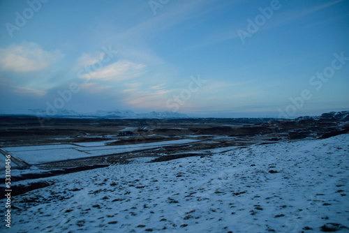 Iceland blue hour with light clouds over winter mountain landscape with snow