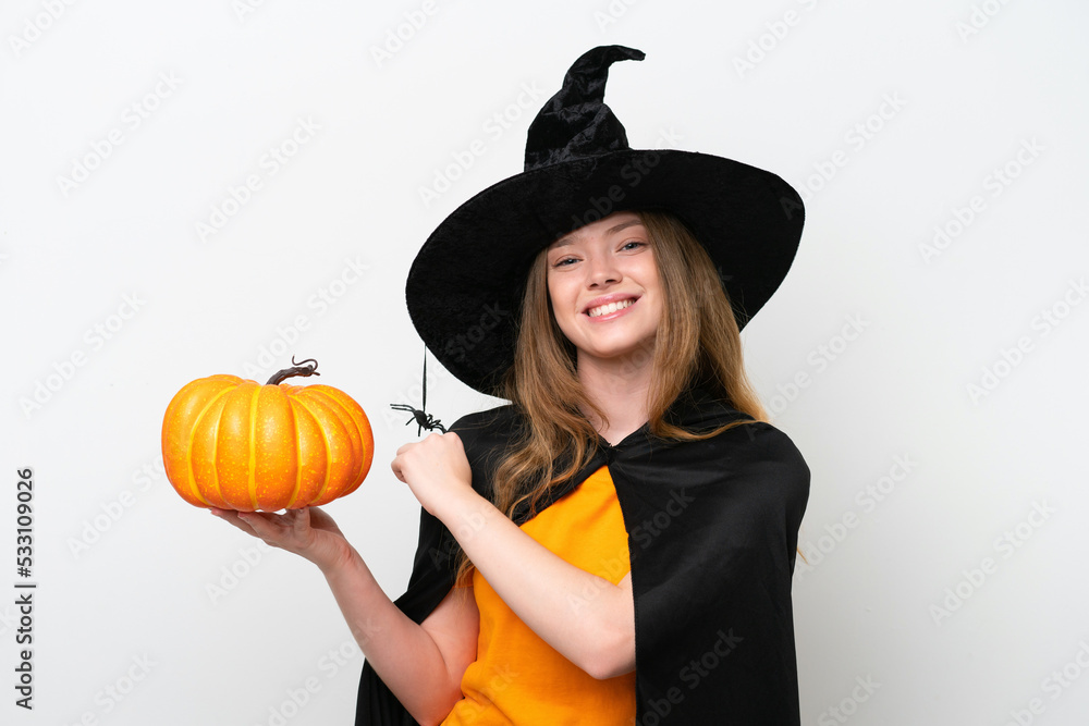 Young pretty woman costume as witch holding a pumpkin isolated on white background celebrating a victory Young pretty woman costume as witch holding a pumpkin isolated on white background celebrating a victory