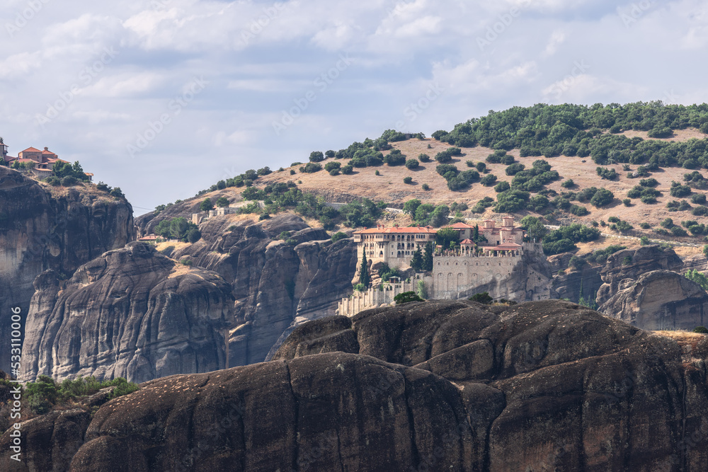 This mountain range of 300-400 m high covered with sparse forest hosts medieval holy monasteries of Varlaam and Great Meteoron on tiny rocky plateaus in visibility to each other, Meteora, Greece This mountain range of 300-400 m high covered with sparse forest hosts medieval holy monasteries of Varlaam and Great Meteoron on tiny rocky plateaus in visibility to each other, Meteora, Greece