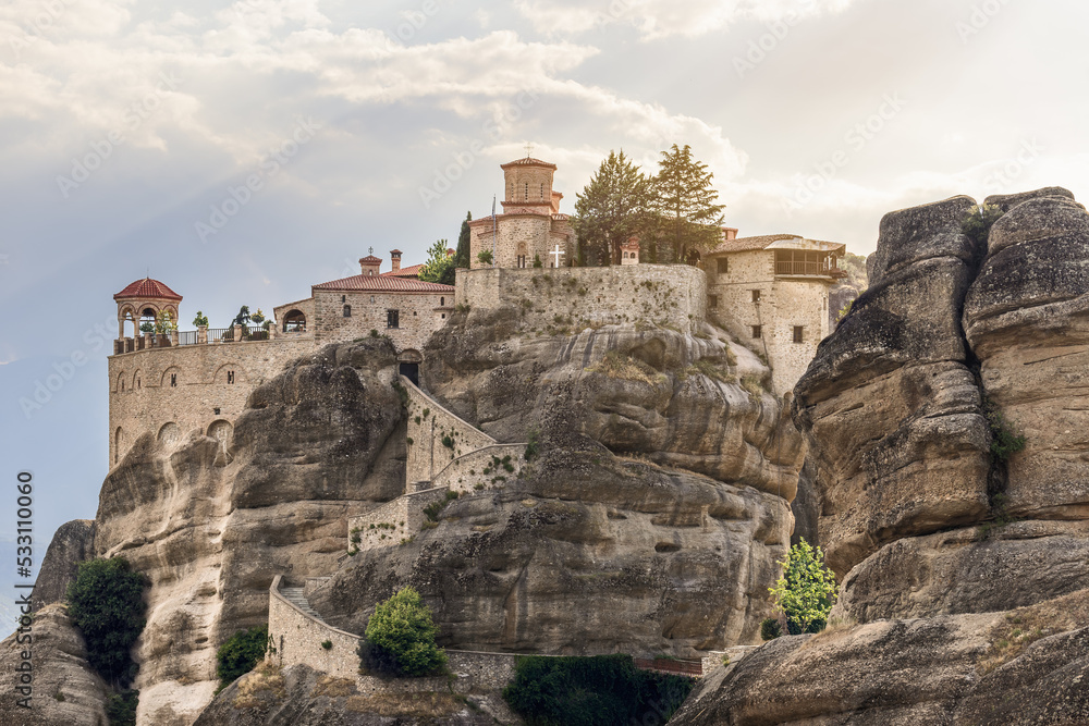 The tourists have to walk up 140 steps of this curly stairway cut into the solid rock to explore the medieval architectural masterpiece - The Holy St. Varlaam Monastery in Meteora, Greece