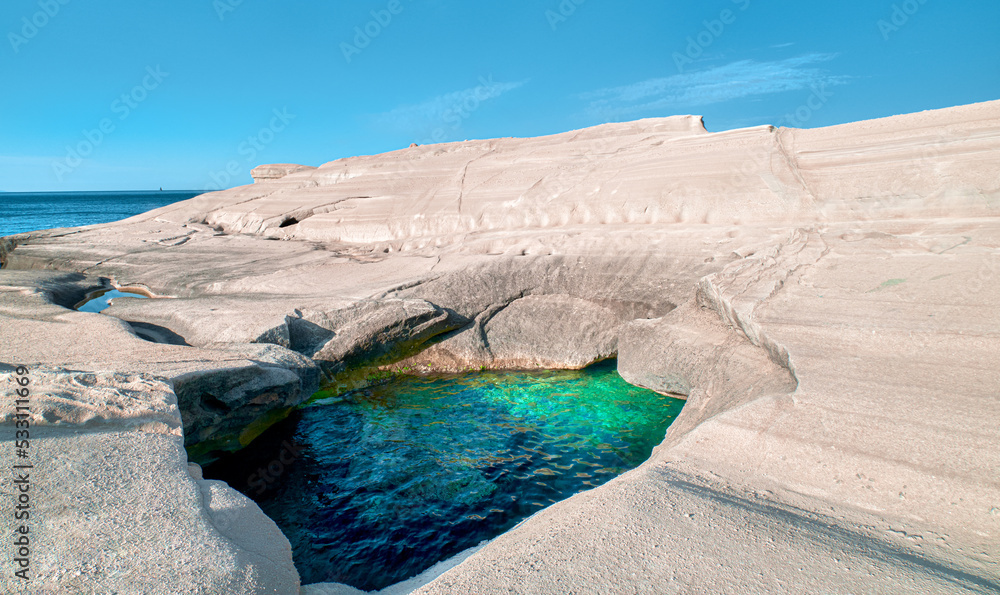 Unique white rocks and emerald green water in sea cave, Sarakiniko