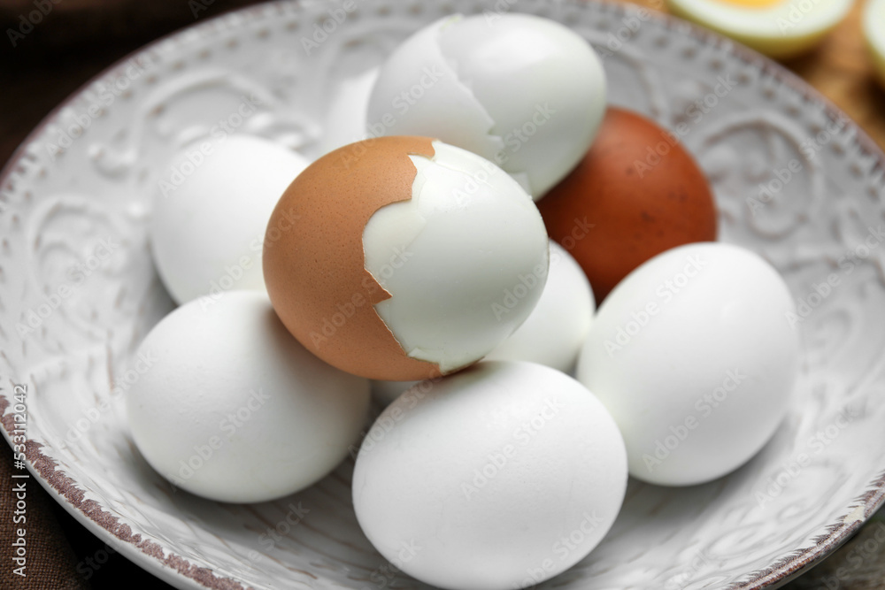 Many boiled eggs on plate, closeup view Many boiled eggs on plate, closeup view