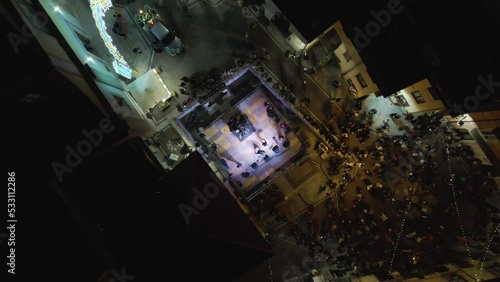 Aerial view of people playing music on stage in Ospedaletto d'Alpinolo during A Juta a Montevergine, a traditional folk festival in Avellino, Irpinia, Italy. photo