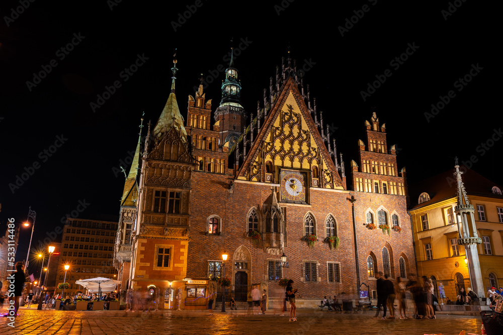 Wroclaw central market square with old houses, town hall and sunset. Panoramic night view, long exposure. Historical capital of Silesia, Wroclaw (Breslau), Poland, Europe.