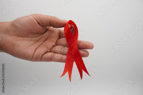 World aids day, red silk ribbon symbol of AIDS Awarenesss photo