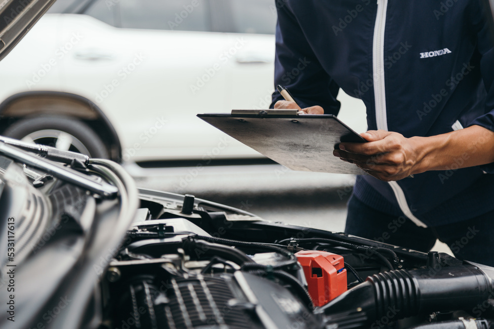 Automobile mechanic repairman hands repairing a car engine automotive workshop with a wrench, car service and maintenance,Repair service. Automobile mechanic repairman hands repairing a car engine automotive workshop with a wrench, car service and maintenance,Repair service.