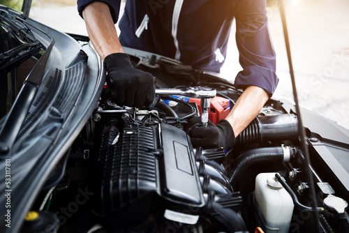Automobile mechanic repairman hands repairing a car engine automotive workshop with a wrench, car service and maintenance , Repair service © A Stockphoto