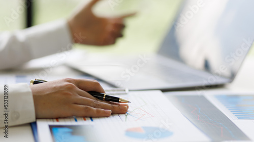 Businesswoman accountant or financial expert analyze business report graph and finance budget chart in the office. Concept of finance economy, banking business and stock market research.