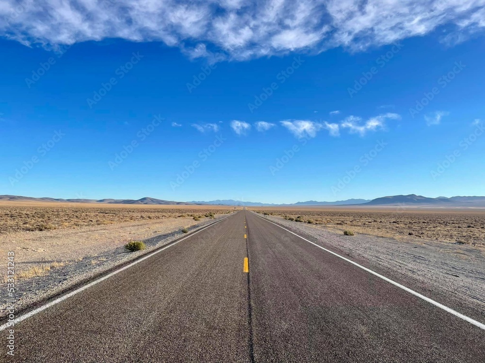 Highway 376 in sunny day, endless road with clear sky and mountains in the background. Highway 376 in sunny day, endless road with clear sky and mountains in the background.