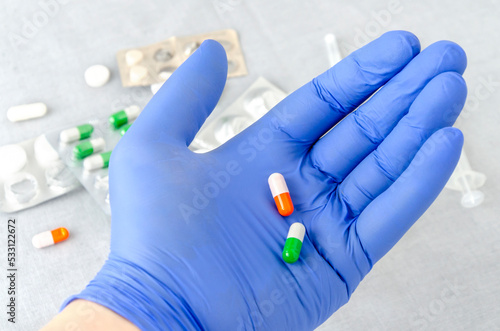 hand in glove holding pills